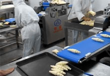 Máquina enrolladora de Croissant en pleno trabajo